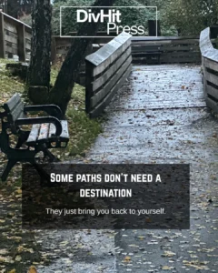 Empty park bench beside wooden trail covered in autumn leaves — DivHit Press visual reflection on stillness and self-discovery in Langley.